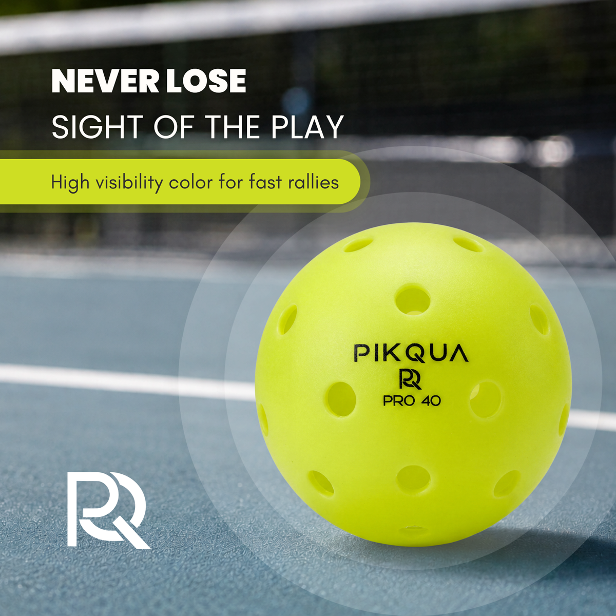 A bright neon yellow pickleball on a blue court with promotional text reading 'NEVER LOSE SIGHT OF THE PLAY' and the brand name PIKQUA PRO 40 printed on the ball.
