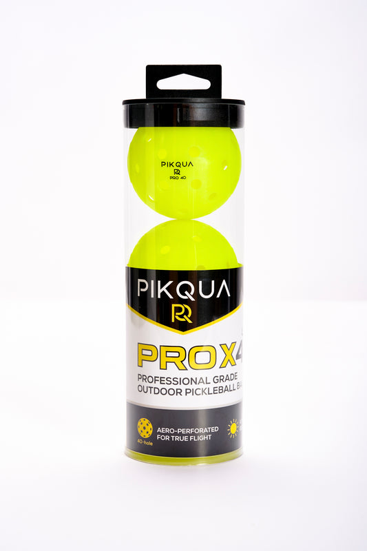 A package of three bright neon yellow pickleballs in a clear cylindrical plastic case with a black lid and a black-and-yellow PIKQUA PROX4 label, photographed on a white background.