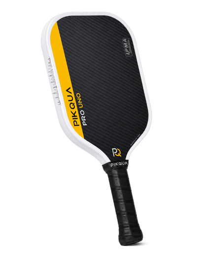 Pikqua Pro Uno pickleball paddle with a black Blue Kevlar pattern face, a bright yellow side accent, and a black wrapped handle, shown on a solid white background.