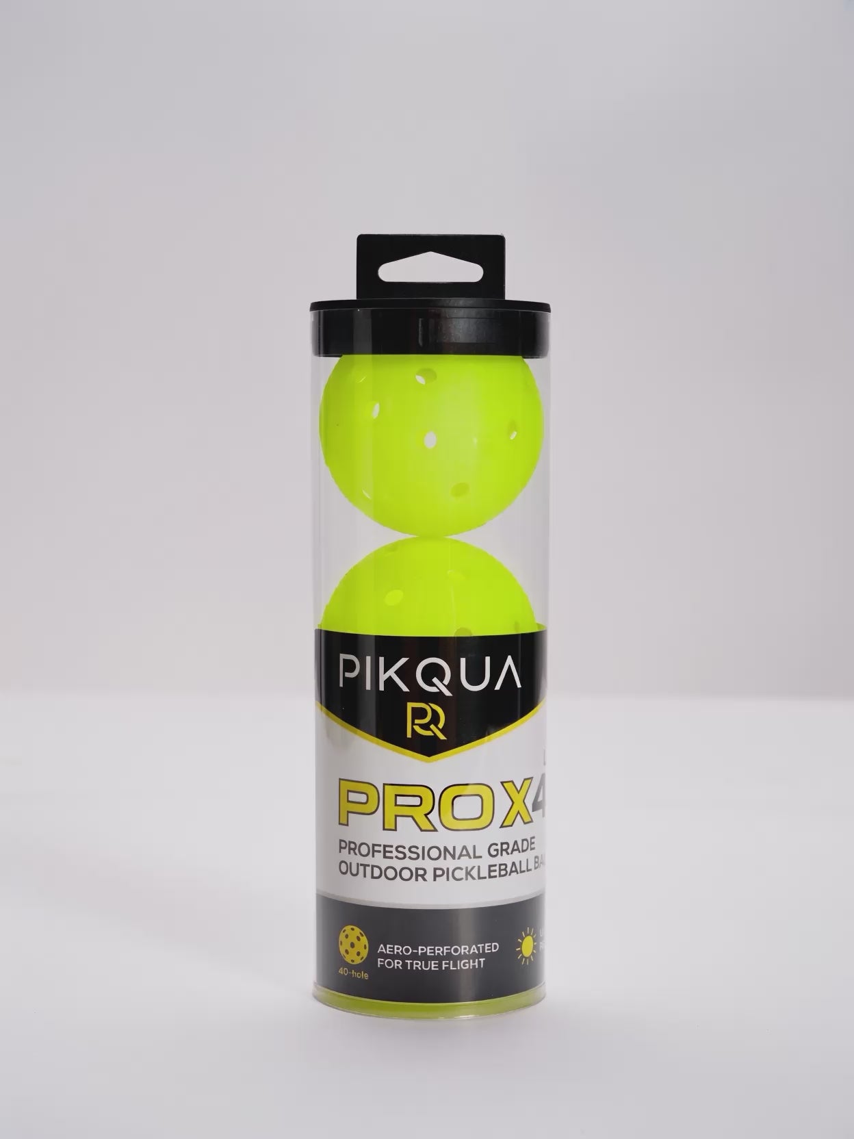 A video of a package of three bright neon yellow pickleballs in a clear cylindrical plastic case with a black lid and a black-and-yellow PIKQUA PROX4 label, photographed on a white background.